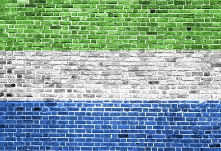 Flag of Sierra Leone painted on brick wall, background textureの写真素材