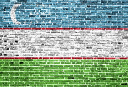 Flag of Uzbekistan painted on brick wall, background textureの写真素材