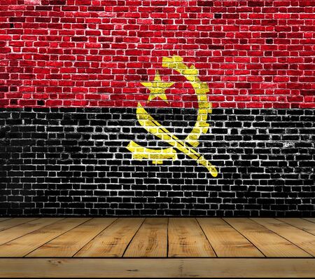 Angola flag painted on brick wall with wooden floorの写真素材