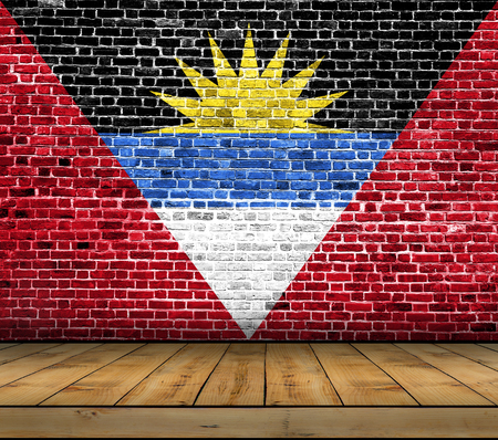 Antigua Barbuda flag painted on brick wall with wooden floorの写真素材