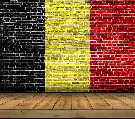 Belgium flag painted on brick wall with wooden floorの写真素材