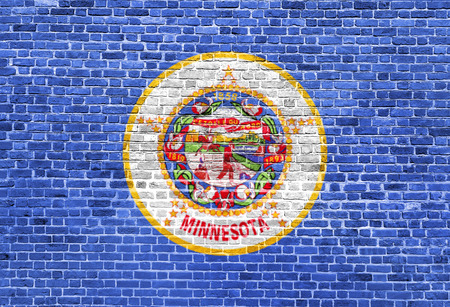 Minnesota US flag painted on old vintage brick wallの写真素材