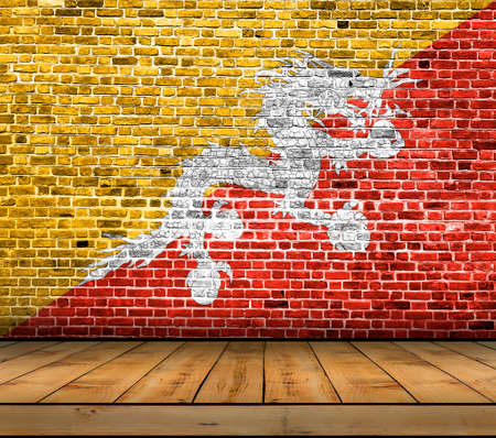 Bhutan flag painted on brick wall with wooden floorの写真素材