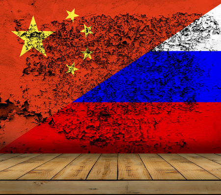 China and Russia flag painted on grunge wall with wooden floorの写真素材
