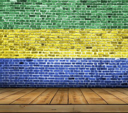 Gabon flag painted on brick wall with wooden floorの写真素材