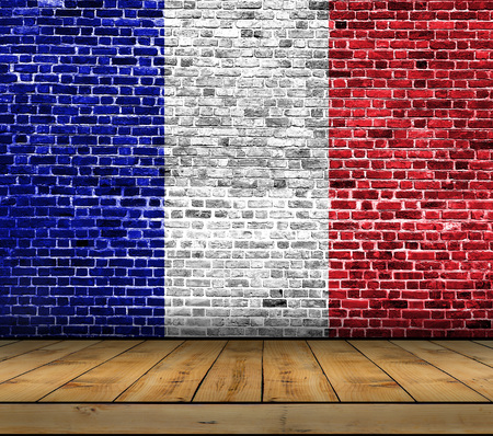 France flag painted on brick wall with wooden floorの写真素材