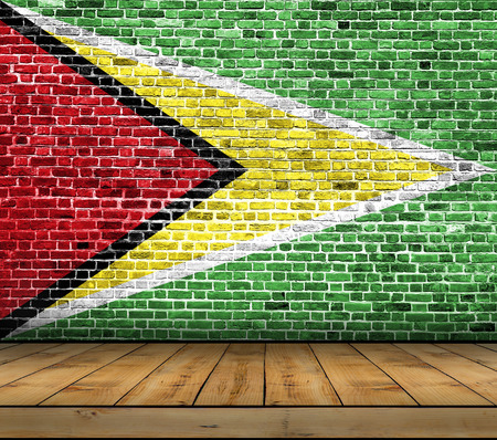 Guyana flag painted on brick wall with wooden floorの写真素材