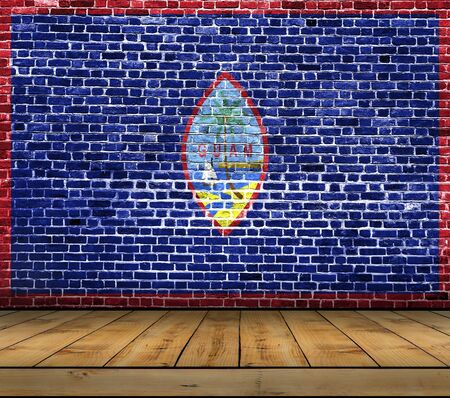 Guam flag painted on brick wall with wooden floorの写真素材