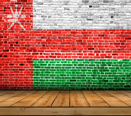 Oman flag painted on brick wall with wooden floorの写真素材