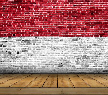 Monaco flag painted on brick wall with wooden floorの写真素材
