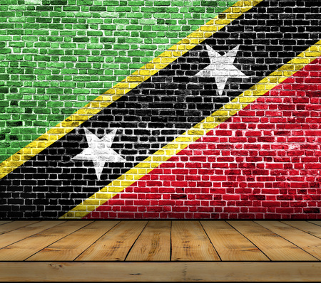 Saint Kittis And Nevis flag painted on brick wall with wooden floorの写真素材
