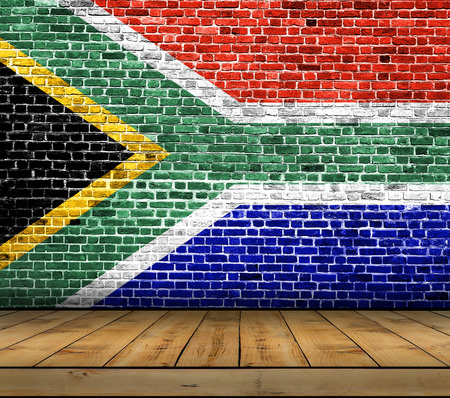 South Africa flag painted on brick wall with wooden floorの写真素材