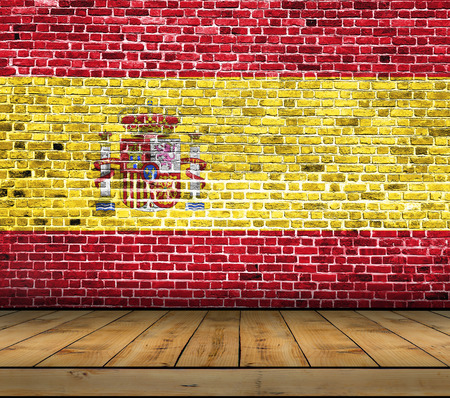 Spain flag painted on brick wall with wooden floorの写真素材