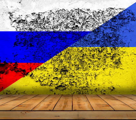 Russia and Ukraine flag painted on mortar wall with wooden floorの写真素材