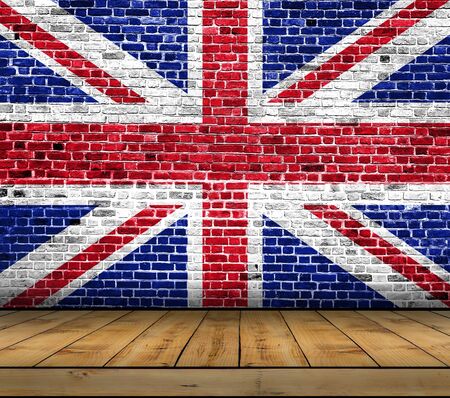 UK flag painted on brick wall with wooden floorの写真素材