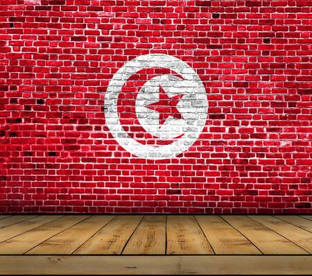 Tunisia flag painted on brick wall with wooden floorの写真素材