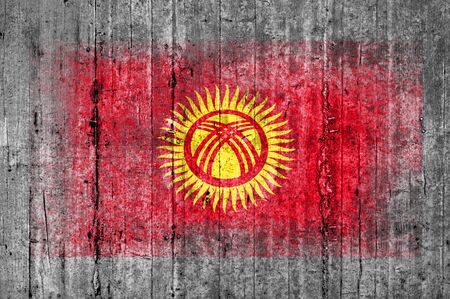 Kyrgyzstan flag painted on background texture gray concreteの写真素材