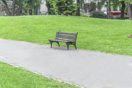 Old rusty bench in the park in the city centerの写真素材