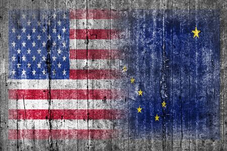 USA and Alaska flag on concrete wallの写真素材