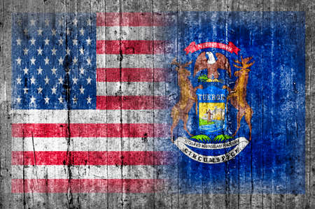 USA and Michigan flag on concrete wallの写真素材