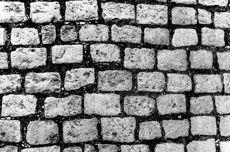 Abstract black and white background of old cobblestone pavementの写真素材