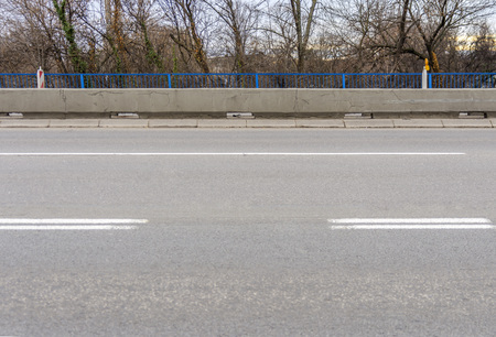 Asphalt empty city road with sidewalk and two lane for trafficの写真素材