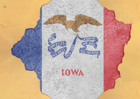 Cracked hole with US state Iowa flag abstract in facade structure big damaged concreteの写真素材