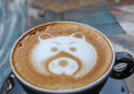 Latte art bear on wooden tableの写真素材