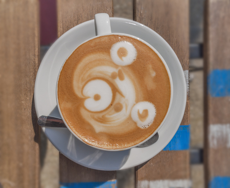 Latte art bear on wooden tableの写真素材
