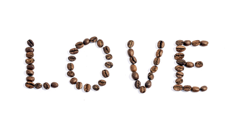 The word love written with coffee beans on white backgroundの写真素材