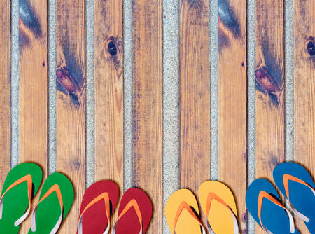 Man lifestyle six relax flip flops on sandy beach wooden path