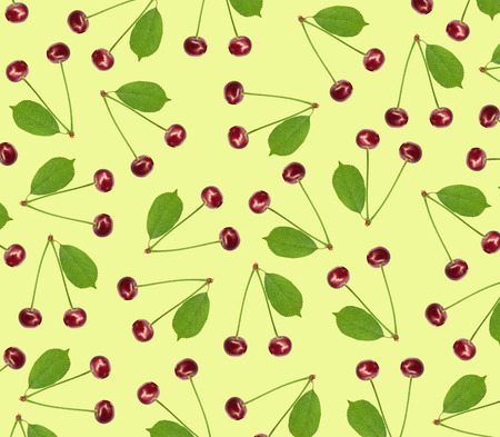 Seamless pattern sweet fresh cherry with green leaf isolated on yellow backgroundの写真素材
