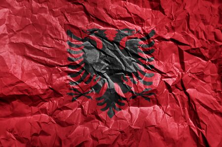 Albania flag painted on crumpled paper backgroundの写真素材