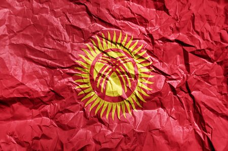 Kyrgyzstan flag painted on crumpled paper backgroundの写真素材