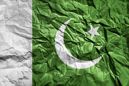 Pakistan flag painted on crumpled paper backgroundの写真素材