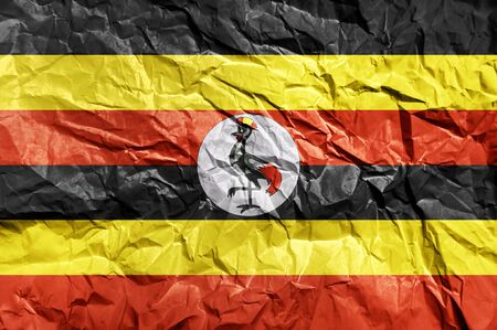 Uganda flag painted on crumpled paper backgroundの写真素材