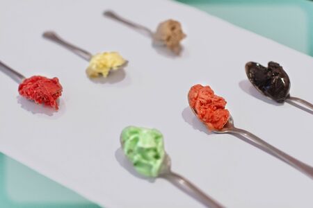 Several gelato ice cream in spoons on white backgroundの写真素材