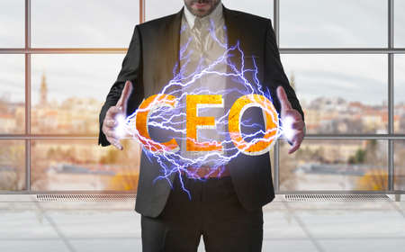 Business man making electricity light with CEO from his hands, recruiting conceptの写真素材