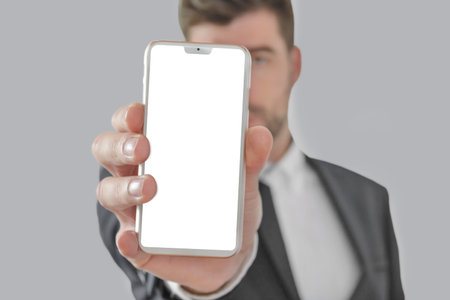 Business, success and technology concept with businessman showing smartphone with blank screen...
