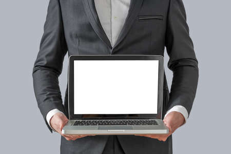 Businessman holding a computer and displaying the screenの写真素材