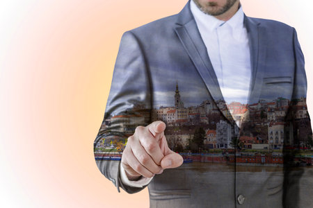 Close up of poiting businessman on day city backgroundの写真素材