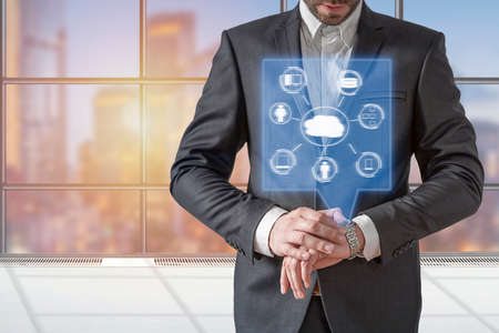 Businessman smartwatch displaying hologram Cloud Computing diagramの写真素材
