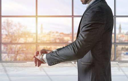 Businessman watching the time at his smartwatch in the office