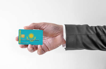 Bank credit plastic card with flag of Kazakhstan holding man in elegant suitの写真素材