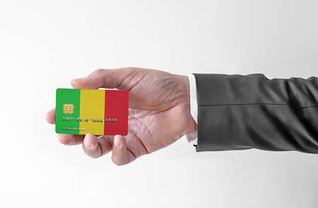 Bank credit plastic card with flag of Mali holding man in elegant suitの写真素材