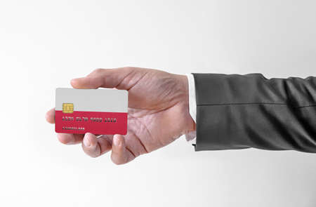 Bank credit plastic card with flag of Poland holding man in elegant suitの写真素材