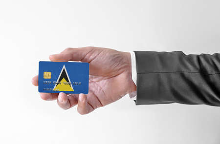 Bank credit plastic card with flag of Saint Lucia holding man in elegant suitの写真素材