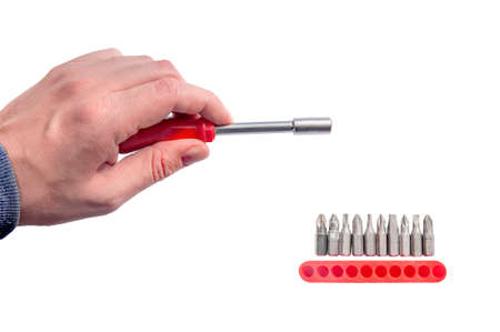 Hand holding chrome industrial screwdriver with one bit extension and replaceable headの写真素材