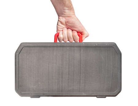 Hand holding plastic aged suitcase isolated on whiteの写真素材