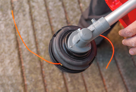 Lawnmower head trimmer for grass like garden machine holding by a man